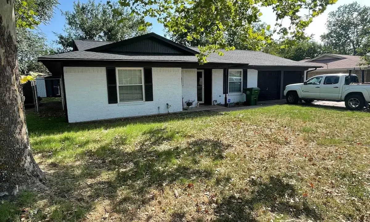 Professional roofing crew working on a residential roof in Fort Lee